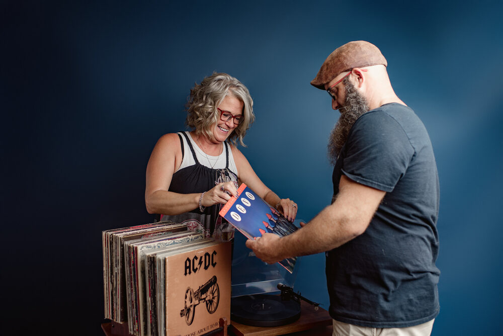 Holding up a bright red vinyl record